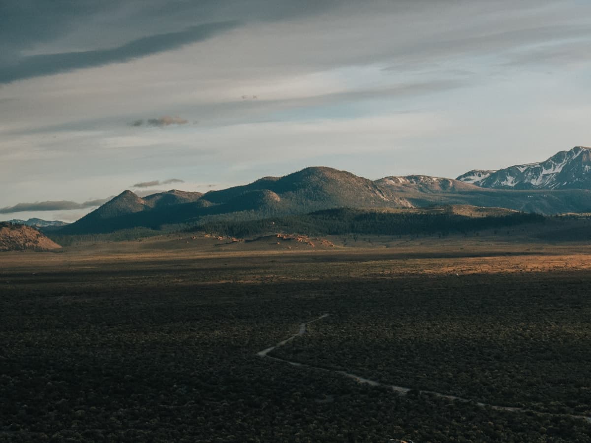 A wide field with mountains rising in the distance — the kind of high-desert ranch country that surrounds Elko, Nevada.