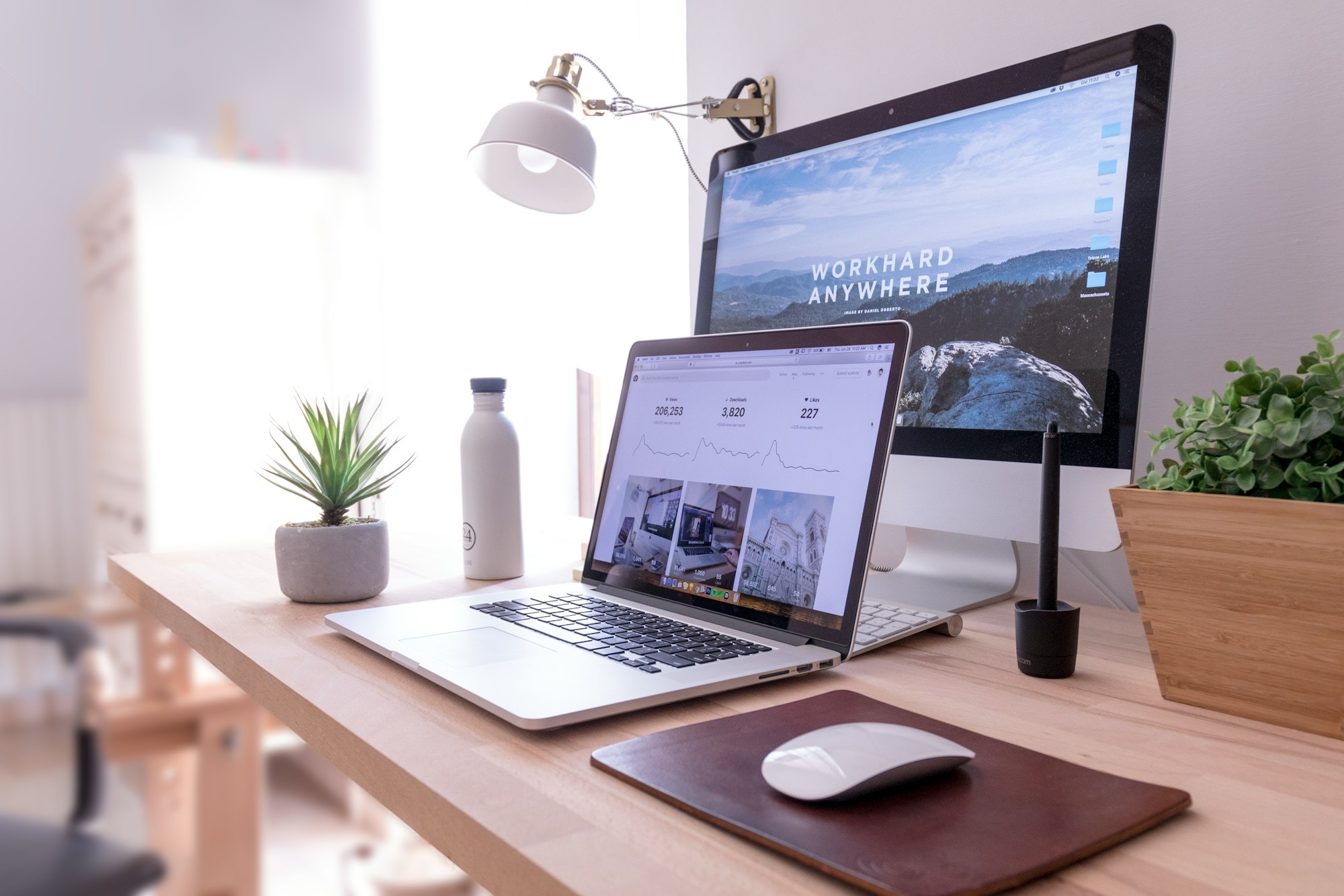 Minimal desk with a laptop and notebook in low light — the calm before signing a contract you won't regret.