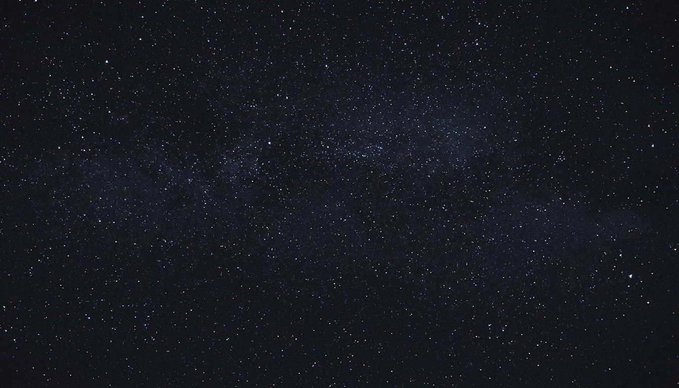 A dense Milky Way starfield against a near-black sky — the visual metaphor for the constellation of Reddit citations that AI answer engines now weave into every local recommendation.